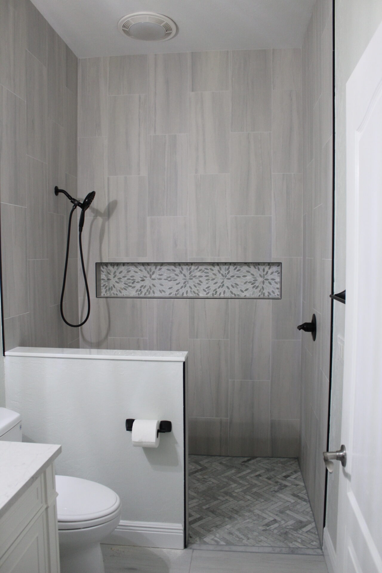 Glass and tile shower detailed after post-renovation cleaning